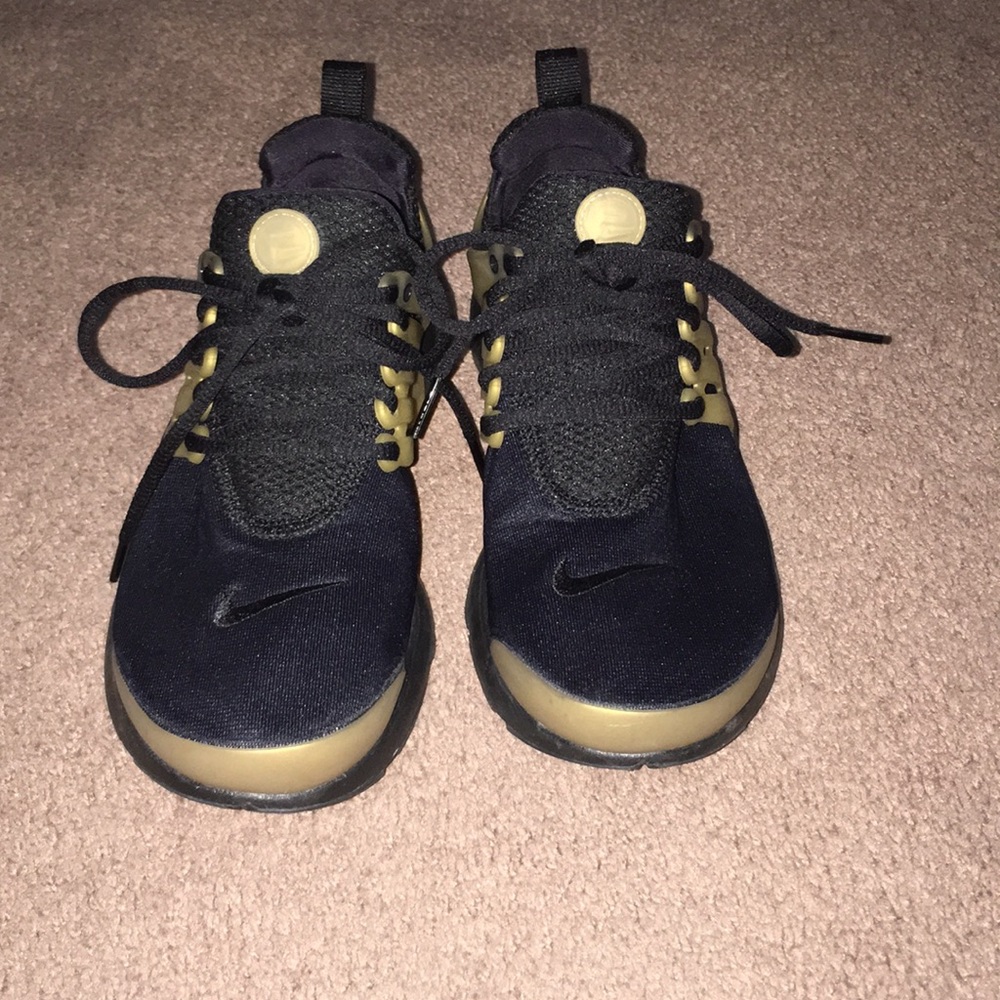 Women Nike black and gold shoes